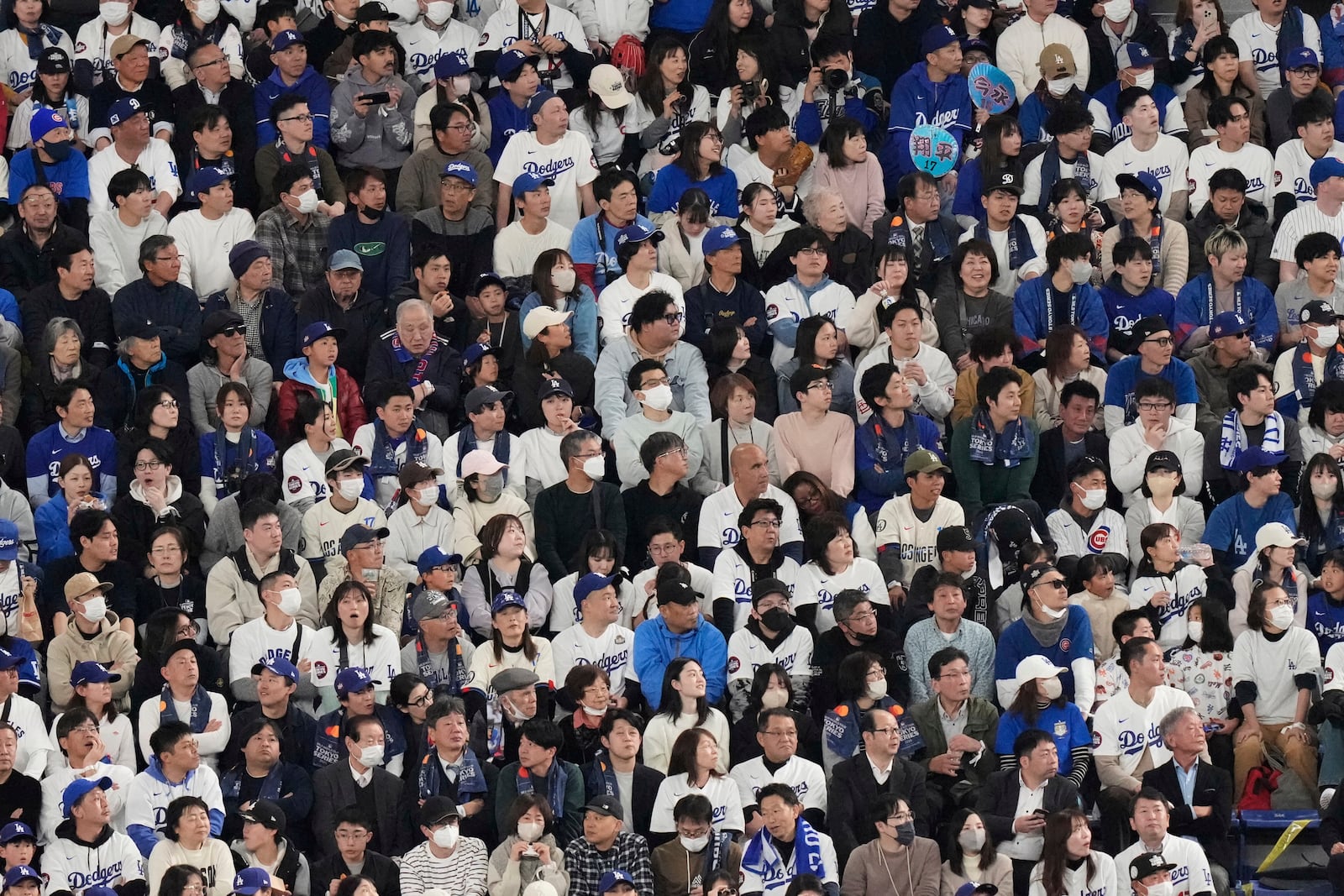 Fans watch the Los Angeles Dodgers play the Chicago Cubs in the first inning of an MLB Japan Series baseball game in Tokyo, Japan, Tuesday, March 18, 2025. (AP Photo/Eugene Hoshiko)