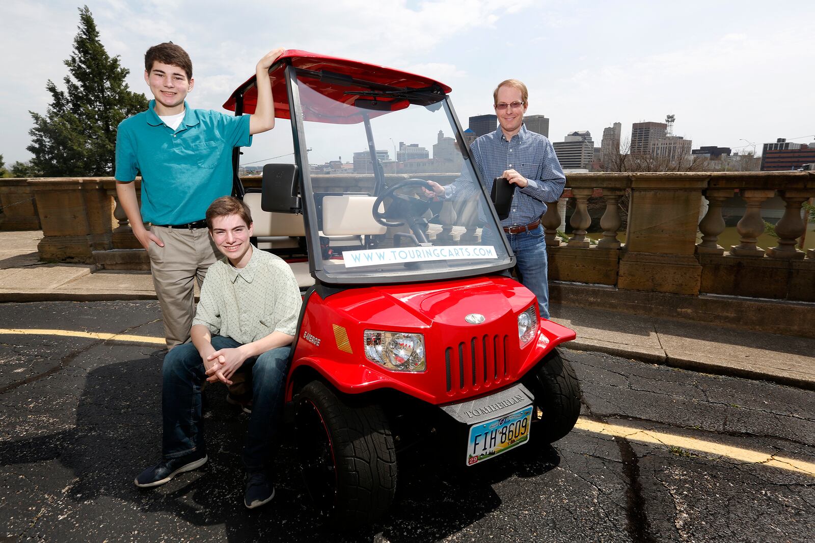 John Meixner of Bellbrook (right) and his sons Aaron, 15, and Alex, 14, have started Touring Carts, a new business that will provide golf cart tours of Dayton. Meixner said he wanted his children to experience what it takes to start a business, so the trio came up with idea for historic tours.  LISA POWELL / STAFF