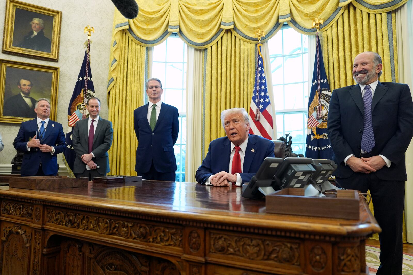 President Donald Trump speaks as Steve Witkoff, special envoy for the Middle East, from left, White House staff secretary Will Scharf, Treasury Secretary Scott Bessent and Commerce Secretary Howard Lutnick listen as Trump signs executive orders in the Oval Office of the White House, Monday, Feb. 3, 2025, in Washington. (AP Photo/Evan Vucci)