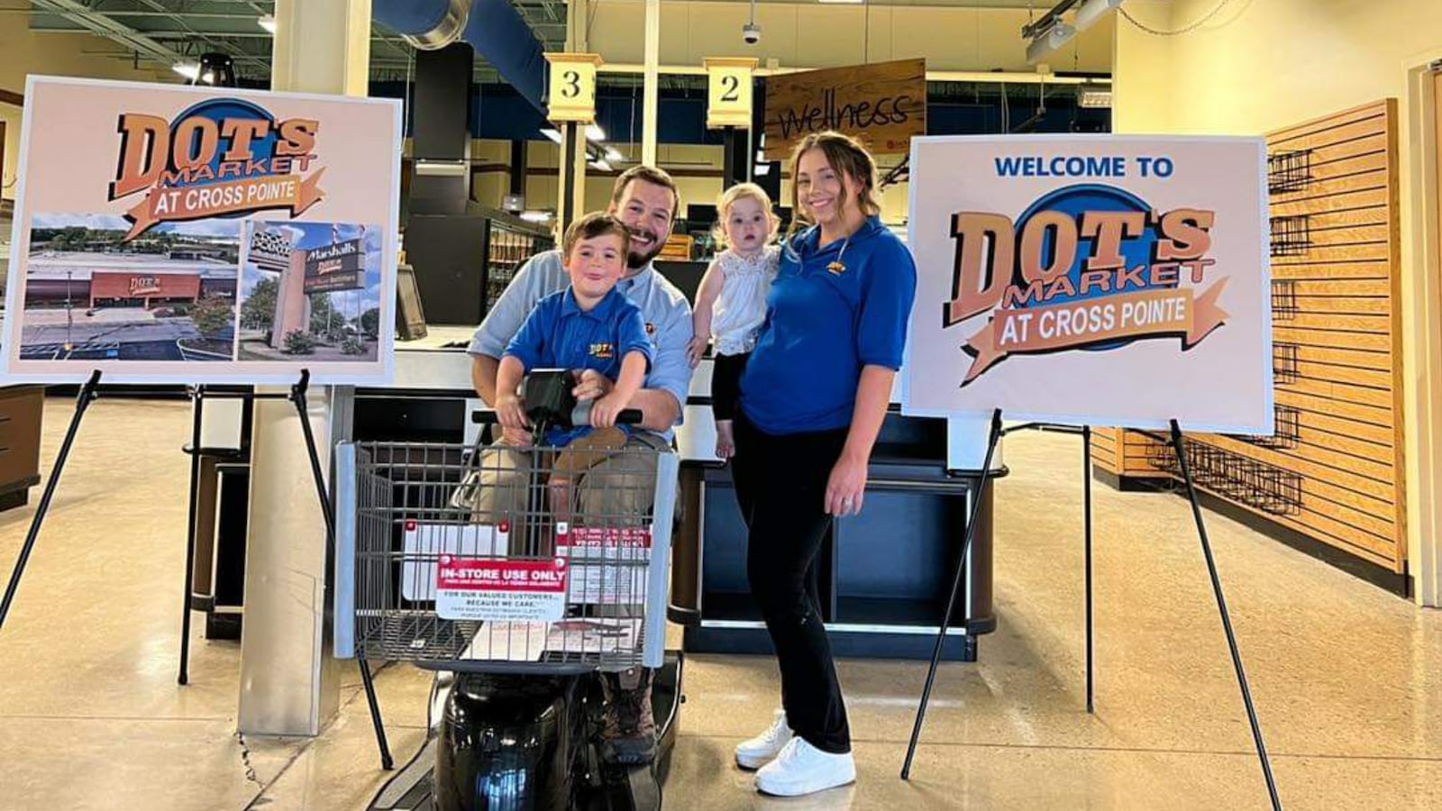 Dot’s Market owner Nick Moshos with his wife, Krystal, and two children, Lucas and Sylvia, inside the new store location.