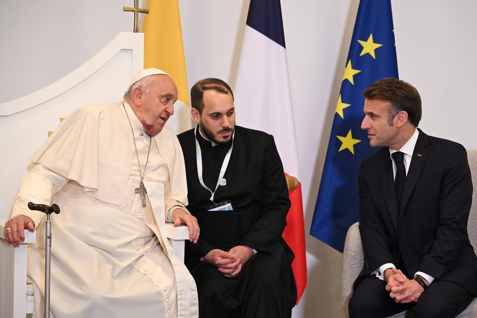 Pope Francis talks with French President Emmanuel Macron in Ajaccio at the end of his one-day visit in the French island of Corsica, Sunday, Dec.15, 2024. (Tiziana Fabi, Pool Via AP)