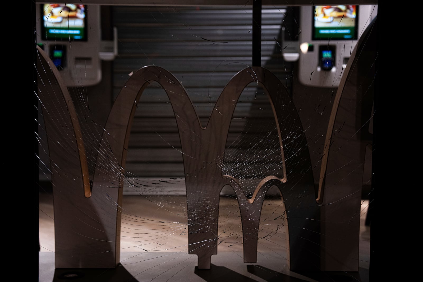 A vandalized window of a McDonalds restaurant during a rally against the "Israel is Forever" gala organized by far-right Franco-Israeli figures over support for Israel, in Paris, Wednesday, Nov. 13, 2024, on the eve of the UEFA Nations League 2025 soccer match between France and Israel. (AP Photo/Louise Delmotte)