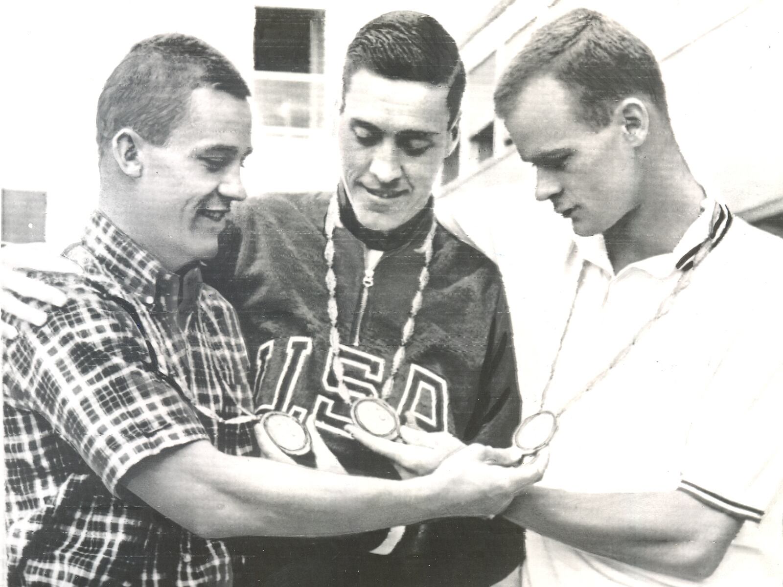 Sam Hall, left, and other Olympic medal winners of the 1960 swim team in Rome. Hall won the Silver for three-meter springboard diving. AP FILE PHOTO