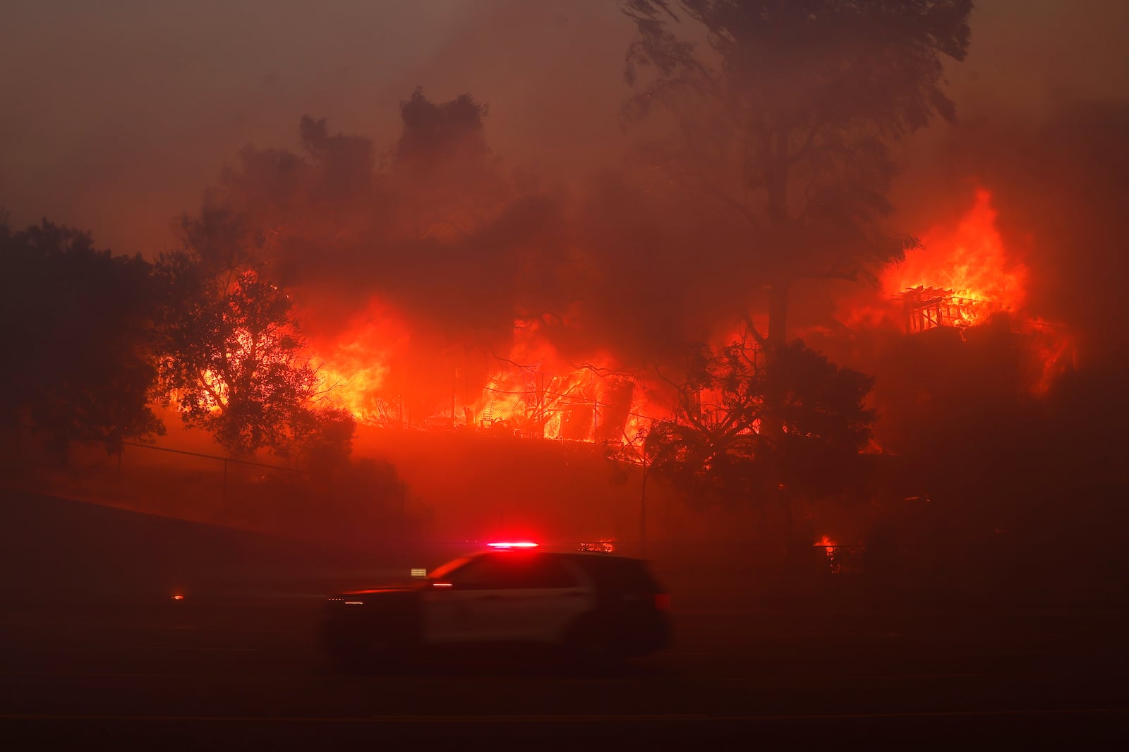 The Palisades Fire burns a property in the Pacific Palisades neighborhood of Los Angeles, Tuesday, Jan. 7, 2025. (AP Photo/Etienne Laurent)