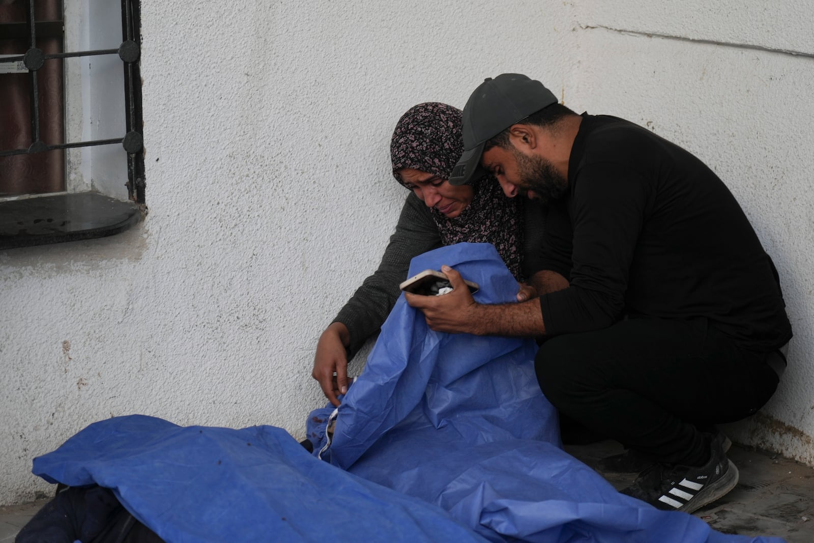 The bodies of Palestinians killed in an Israeli army airstrikes are brought to Shifa hospital in Gaza City, Tuesday, March 18, 2025. (AP Photo/Abdel Kareem Hana)