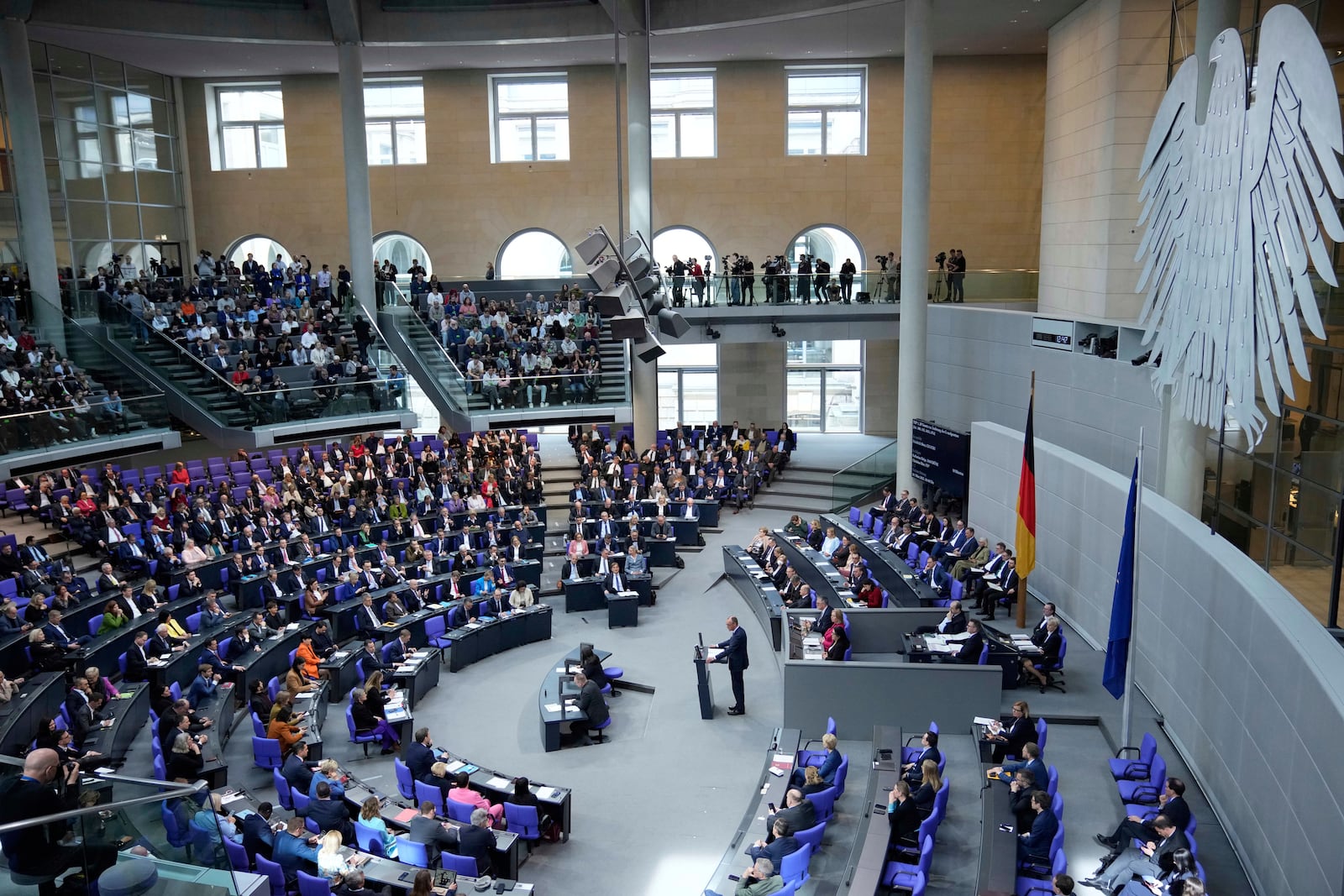 German opposition leader and Christian Democratic Union party chairman Friedrich Merz, center, delivers his speech during a meeting of the German federal parliament, Bundestag, at the Reichstag building in Berlin, Germany, Thursday, March 13, 2025. (AP Photo/Ebrahim Noroozi)