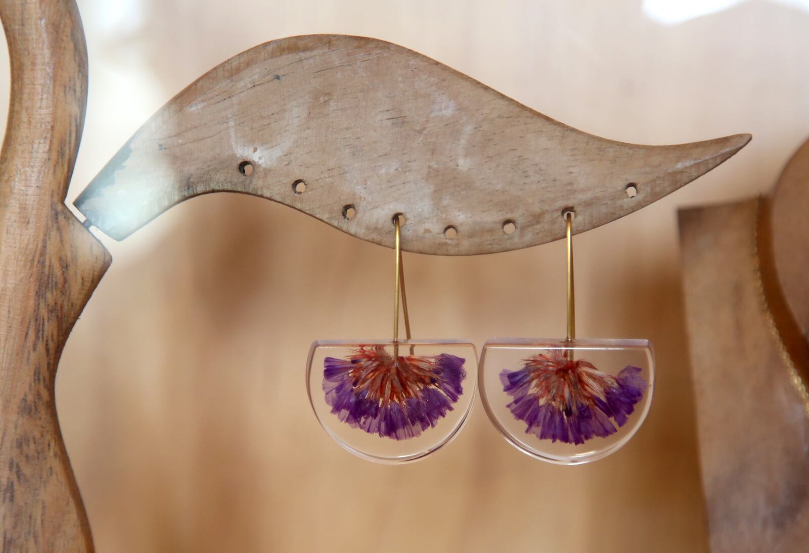 Earrings made of dried flowers inside resin are $39.95 at the Aullwood Audubon Nature Store and Gift Shop. The shop has moved to Aullwood Farm, 9101 Frederick Pike , while the nature center undergoes renovations. The gift shop is a celebration of nature, with something for all ages. LISA POWELL / STAFF