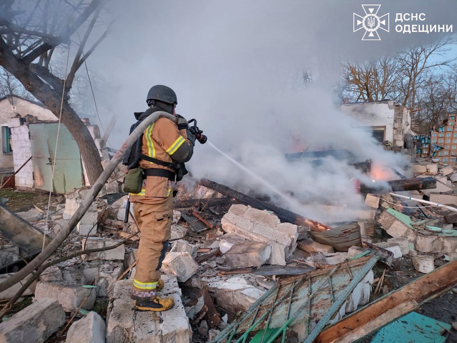 In this photo provided by the Ukrainian Emergency Service, firefighters put out the fire following a Russian attack in Odesa, Ukraine, Friday, March 21, 2025. (Ukrainian Emergency Service via AP)