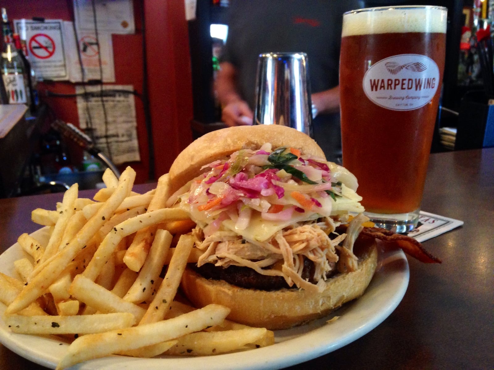 The Hearse Burger at Lucky's taproom in Dayton's Oregon District includes ground steak from Keener Farms near Dayton, cheddar and pepper jack cheese, applewood smoked bacon, red cabbage slaw and  pulled chicken that has been braised in Warped Wing's Flyin' Ale. (Photo by Amelia Robinson)