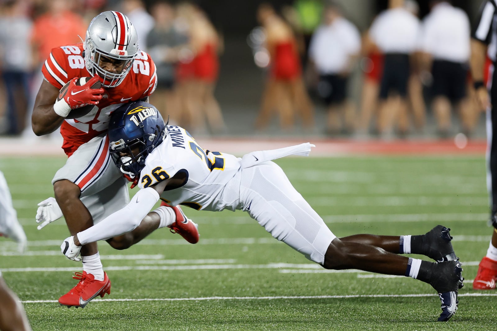 Toledo defensive back Jaylin Mines, right, tackles Ohio State running back TC Caffey during the second half of an NCAA college football game Saturday, Sept. 17, 2022, in Columbus, Ohio. (AP Photo/Jay LaPrete)