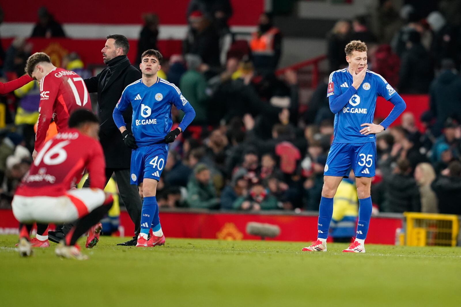 From right: Leicester's Kasey McAtee, Facundo Buonanotte and head coach Ruud van Nistelrooy react after the English FA Cup fourth round soccer match between Manchester United and Leicester City at the Old Trafford stadium in Manchester, England, Friday, Feb. 7, 2025. (AP Photo/Dave Thompson)