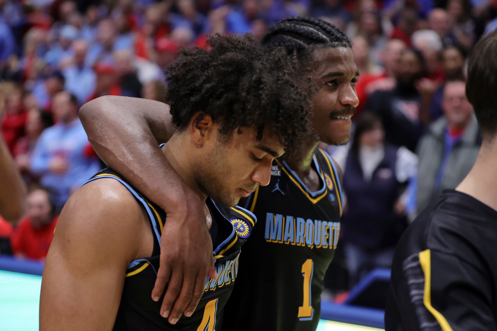 Marquette guard Stevie Mitchell, left, and guard Kam Jones (1) walk off the court after an NCAA college basketball game against Dayton in Dayton, Ohio, Saturday, Dec. 14, 2024. (AP Photo/Paul Vernon)