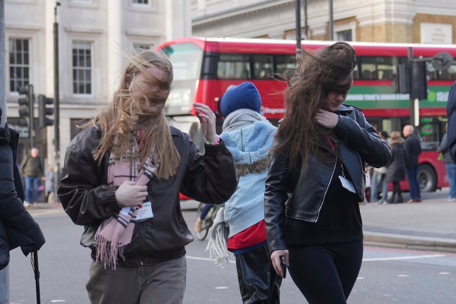 People brave the wind as storm Eowyn hits the country in London, Friday, Jan. 24, 2025. (AP Photo/Kin Cheung)