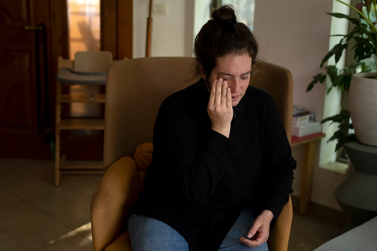 Yifat Zailer, whose cousin, Sheri Bibas, her husband and sons are being held hostage by Hamas militants in the Gaza Strip, weeps during an interview at home in Herziliyya, Israel, on Wednesday, Jan. 15, 2025. (AP Photo/Maya Alleruzzo)