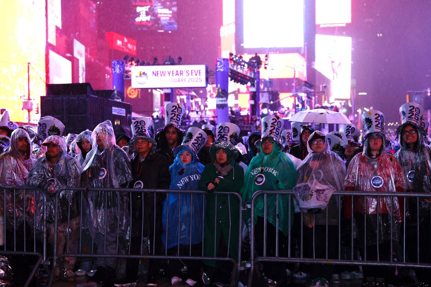 New Year’s Eve revelers stand in a downpour as they await the stroke of midnight in New York’s Times Square on Tuesday night, Dec. 31, 2024. (Adrienne Grunwald/The New York Times)