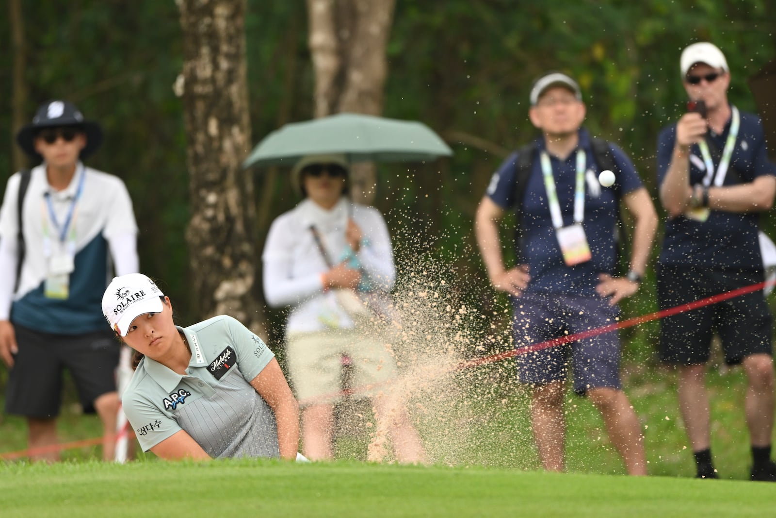 Jin Young Ko of South Korea hits out of a bunker on the 8th green during the first round of the LPGA Honda Thailand golf tournament in Pattaya, southern Thailand, Thursday, Feb. 20, 2025. (AP Photo/Kittinun Rodsupan)