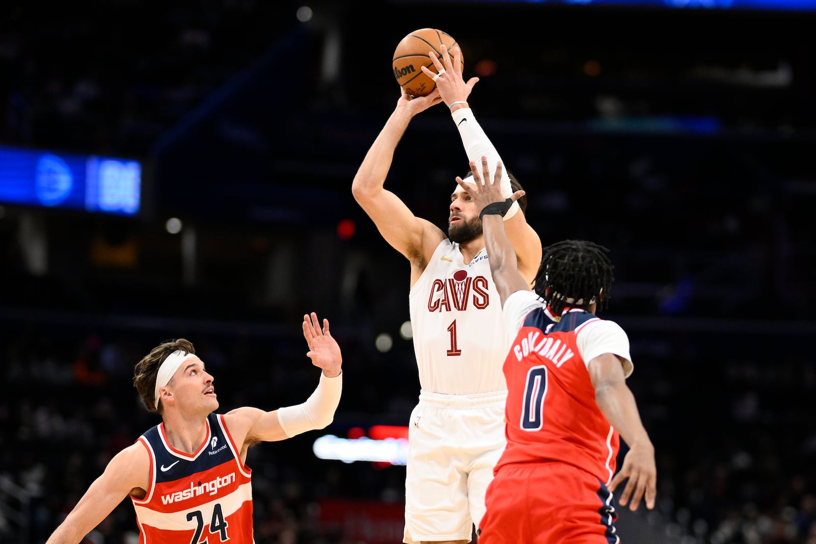 Cleveland Cavaliers guard Max Strus (1) looks to shoot against Washington Wizards guard Bilal Coulibaly (0) and forward Corey Kispert (24) during the first half of an NBA basketball game, Friday, Feb. 7, 2025, in Washington. (AP Photo/Nick Wass)