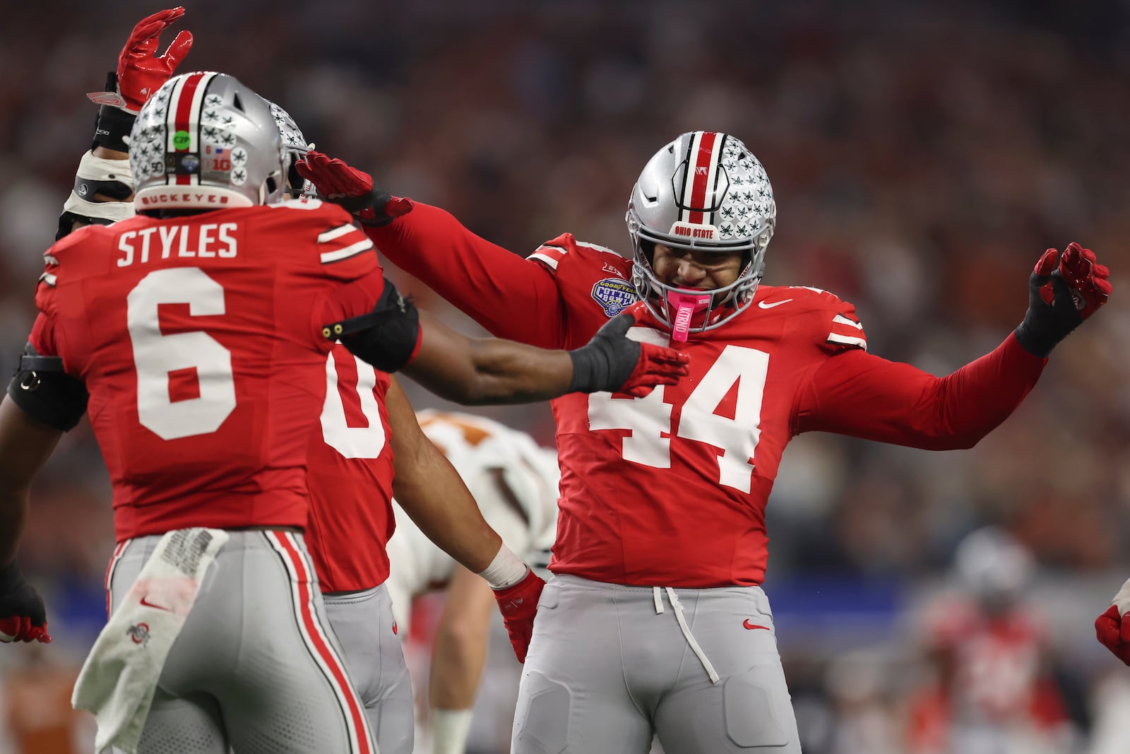 Ohio State safety Sonny Styles (6) celebrates with defensive end JT Tuimoloau (44) during the first half of the Cotton Bowl College Football Playoff semifinal game against Texas, Friday, Jan. 10, 2025, in Arlington, Texas. (AP Photo/Gareth Patterson)