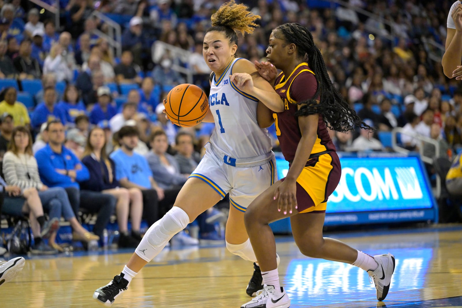 UCLA guard Kiki Rice, left, drives past Minnesota guard Alexsia Rose, right, during the second half of an NCAA college basketball game Sunday, Feb. 2, 2025, in Los Angeles. (AP Photo/Jayne Kamin-Oncea)