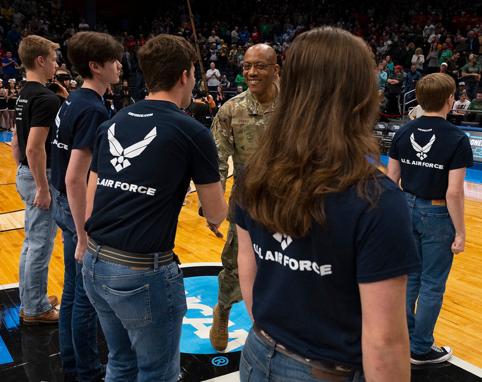 Air Force Chief of Staff Gen. CQ Brown Jr. congratulates new Air Force recruits after administering the oath of enlistment March 16. A group of 24 new Airmen took the oath during halftime of the NCAA men’s basketball tournament game between Wright State and Bryant at Dayton University Arena. U.S. AIR FORCE PHOTO/R.J. ORIEZ