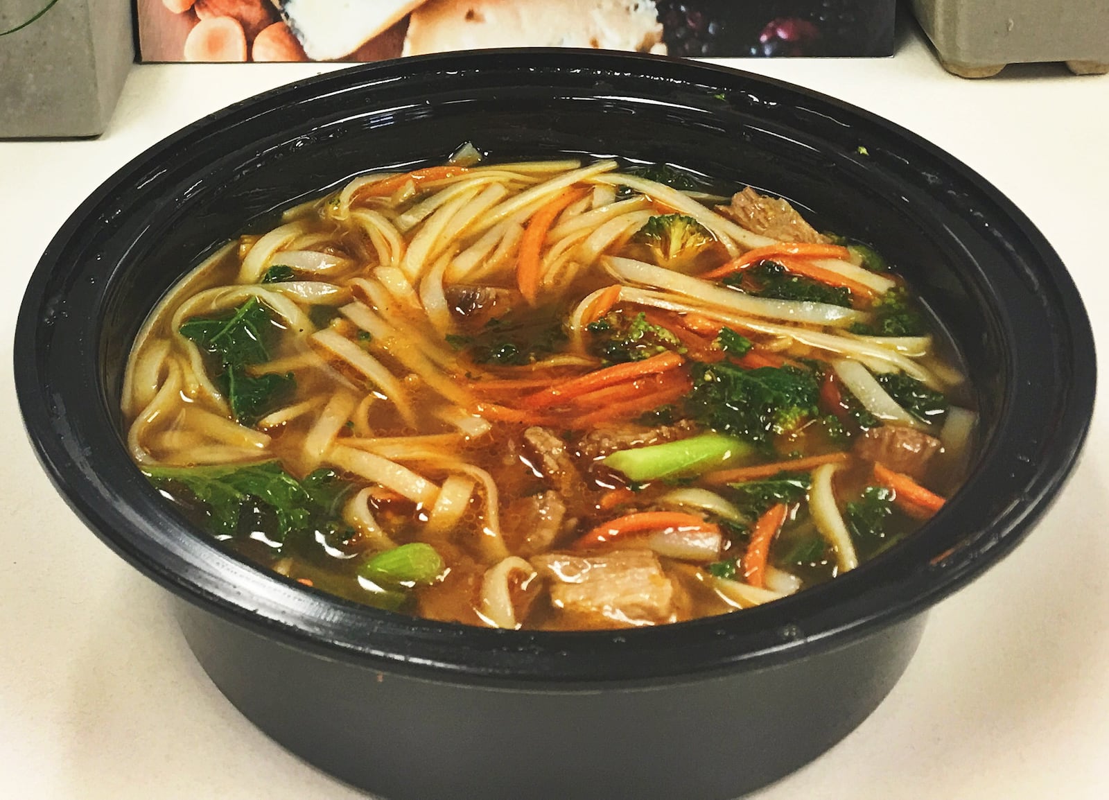 The Spicy Ginger Steak & Rice Noodle broth bowl featured a beef bone broth, grass fed steak, rice noodles, shredded kale, broccoli, carrots, scallions, sliced almonds, ginger, cilantro, sriracha. ALLEGRA CZERWINSKI / STAFF