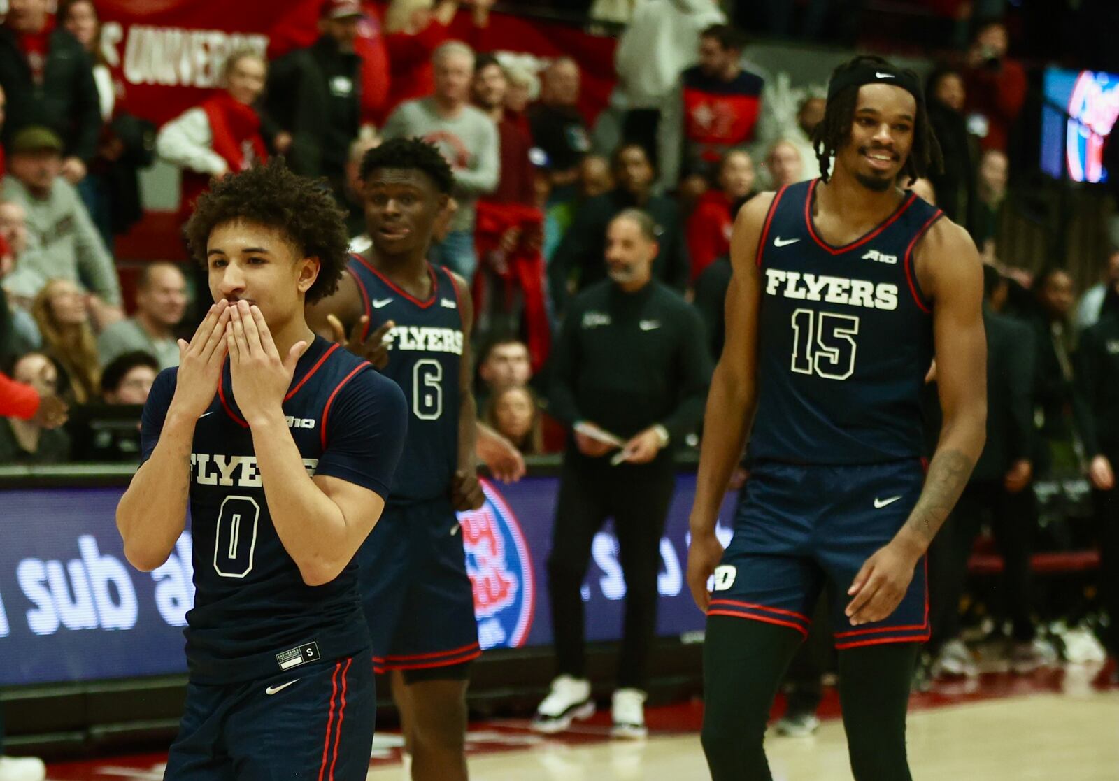 Dayton's Javon Bennett, left, and DaRon Holmes II celebrate a victory against Saint Joseph’s on Tuesday, Feb. 6, 2024, at Hagan Arena in Philadelphia. David Jablonski/Staff