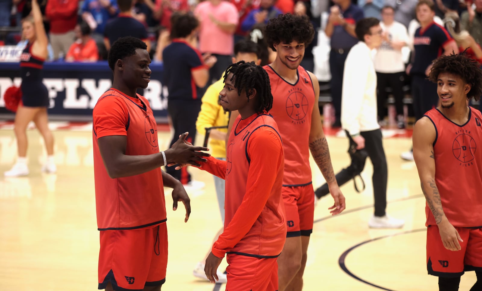 Dayton's Enoch Cheeks and Malachi Smith slap hands during pregame introductions before an exhibition game against Xavier on Sunday, Oct. 20, 2024, at UD Arena. David Jablonski/Staff