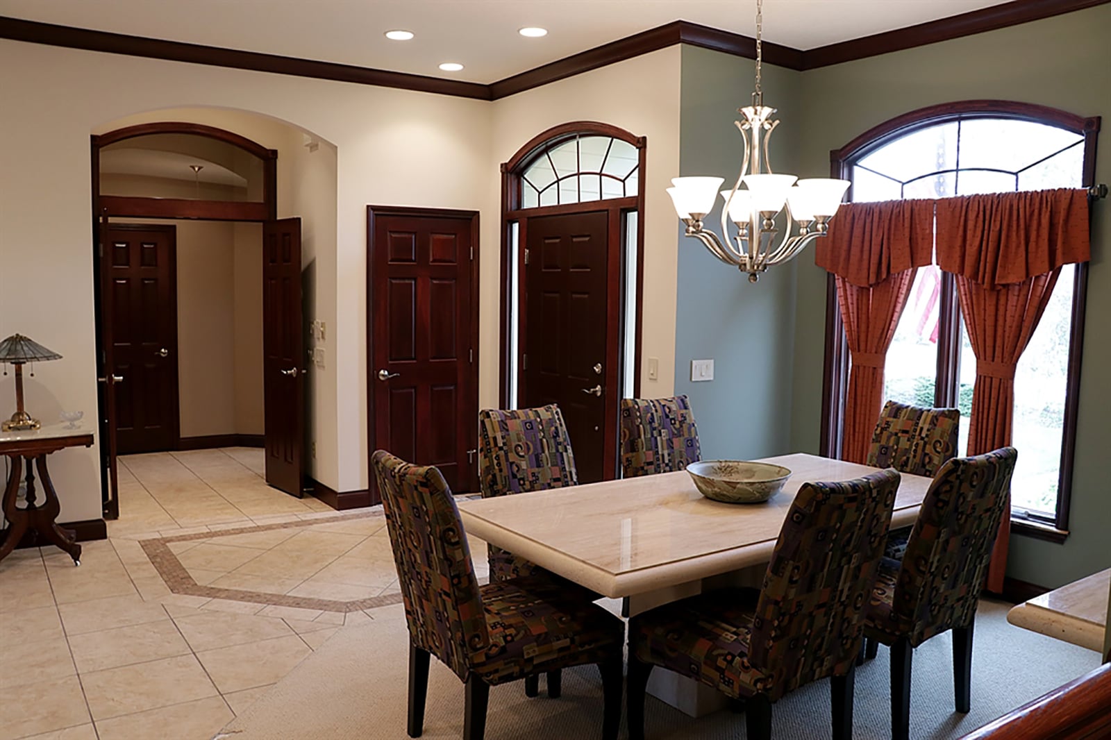 Formal entry opens into a ceramic-tile foyer with mosaic details. The tile creates a walkway between the combined living and dining room and flows into the hallway, kitchen and breakfast room. CONTRIBUTED PHOTO BY KATHY TYLER