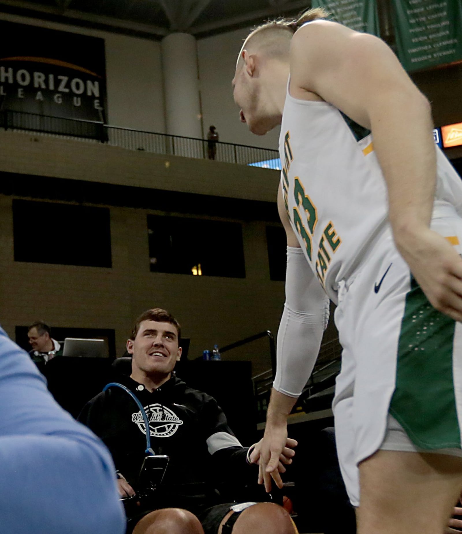 Ryan Custer smiles as teammate Loudon Love, wearing Custer’s No. 33, gives him a greeting during Wright State’s game against IUPUI at the Nutter Center in Fairborn on Sunday, Feb. 16, 2020. Contributed photo by E.L. Hubbard