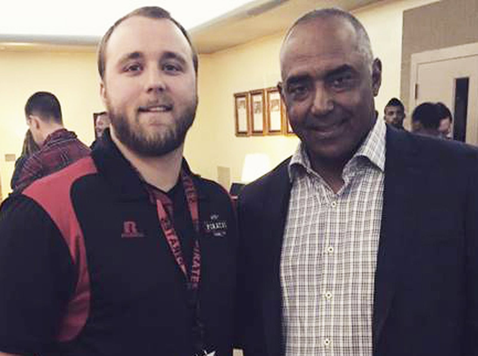 Former West Carrollton High School head football coach Derek Hauk huddles with former Bengals head coach Marvin Lewis. CONTRIBUTED PHOTO