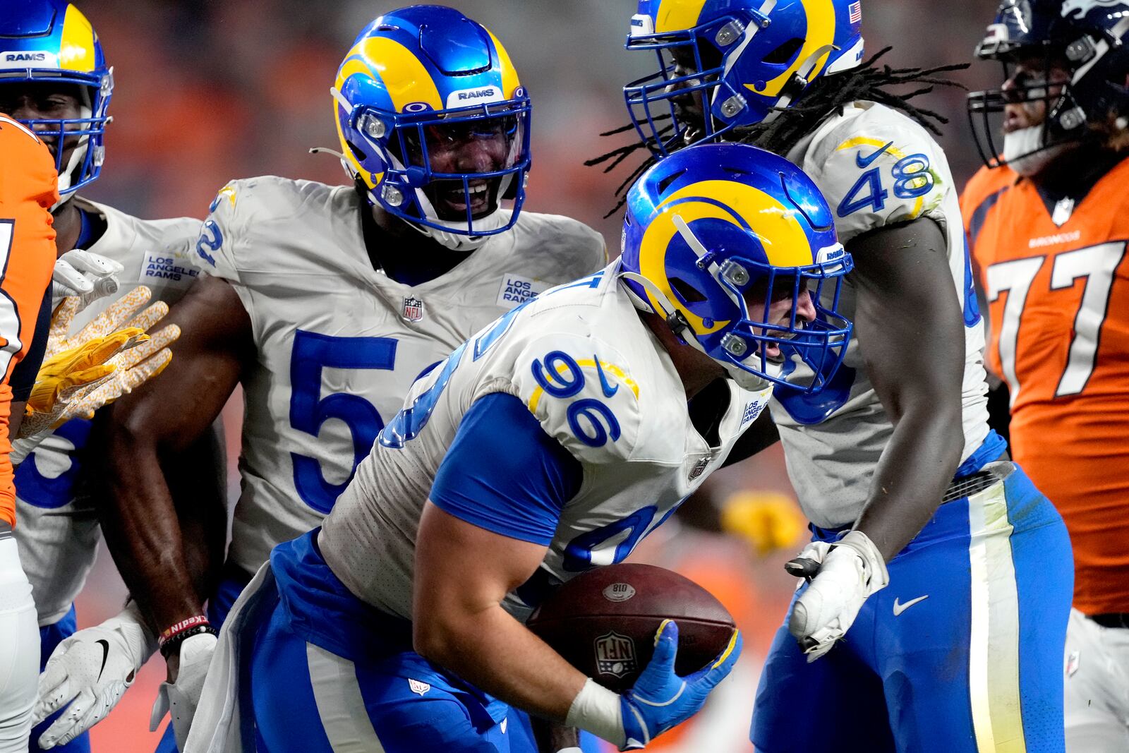 Los Angeles Rams defensive lineman Mike Hoecht (96) celebrates his fumble recovery against the Denver Broncos during the first half of an NFL preseason football game, Saturday, Aug. 28, 2021, in Denver. (AP Photo/David Zalubowski)