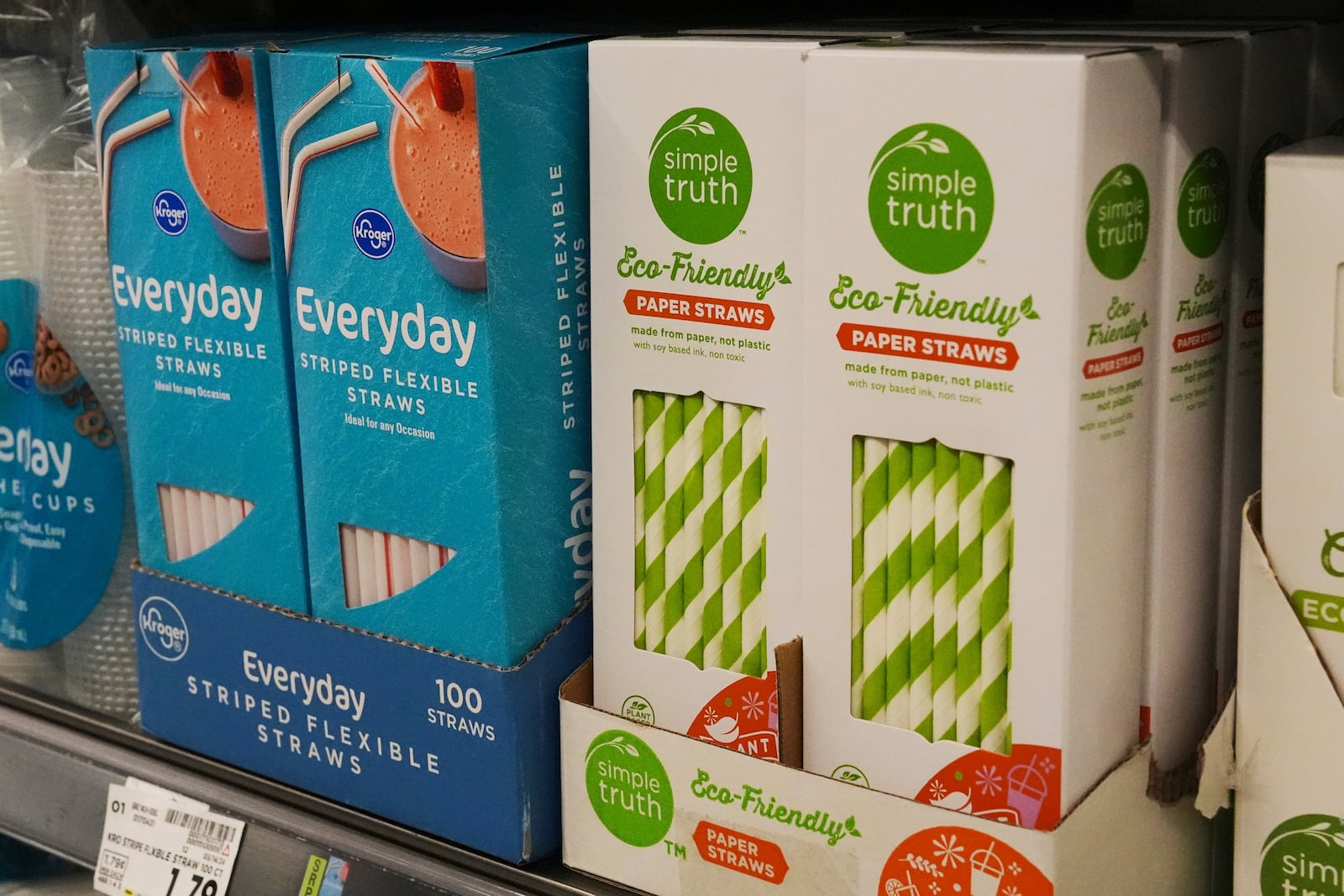 Plastic straws, left, sit next to paper straws on display for sale in Cincinnati on Tuesday, Feb. 11, 2025. (AP Photo/Joshua A. Bickel)