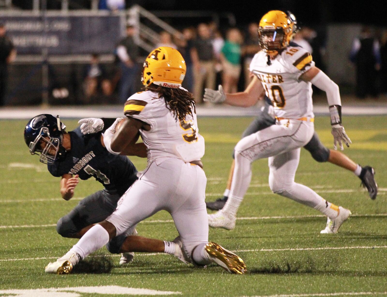 Branden McDonald of Alter (5) takes on Ethan Saum of Fairmont. Alter defeated host Fairmont 21-7 in a Week 1 high school football game on Thursday, Aug. 29, 2019. MARC PENDLETON / STAFF