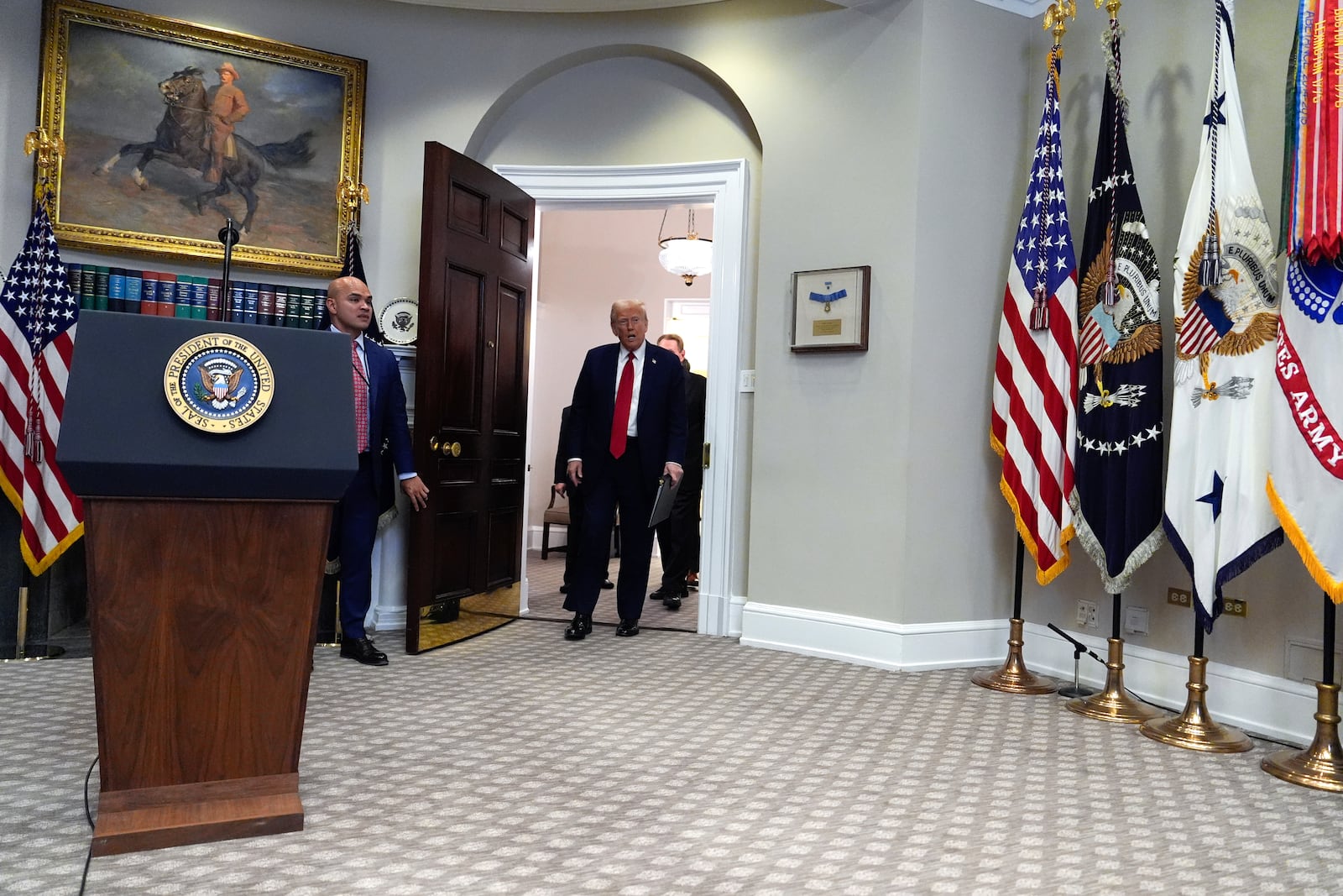 President Donald Trump arrives to speak in the Roosevelt Room at the White House, Tuesday, Jan. 21, 2025, in Washington. (AP Photo/Julia Demaree Nikhinson)