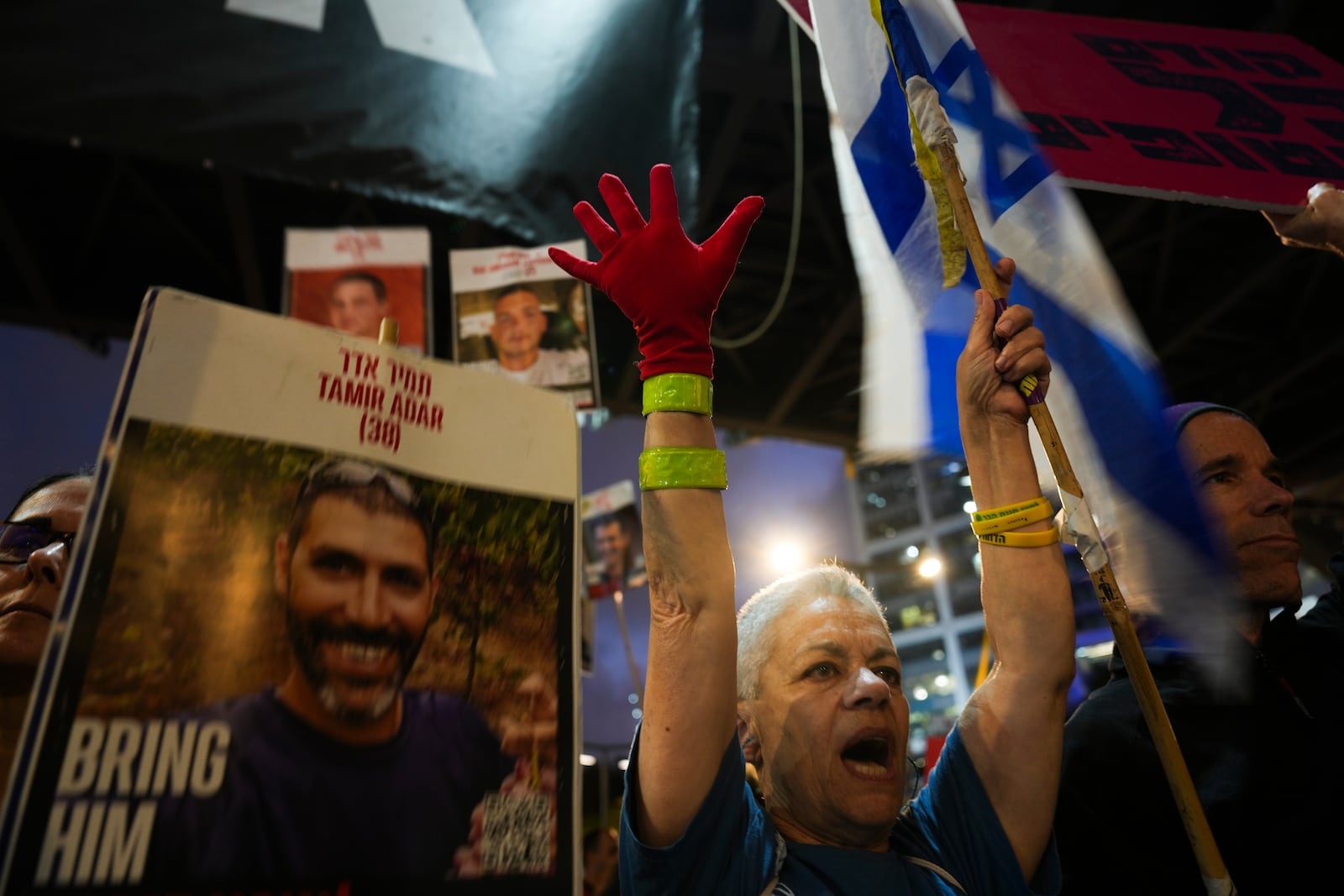 Protesters demand the release of hostages held in the Gaza Strip, in Tel Aviv, Israel, Tuesday, March 18, 2025. (AP Photo/Ariel Schalit)