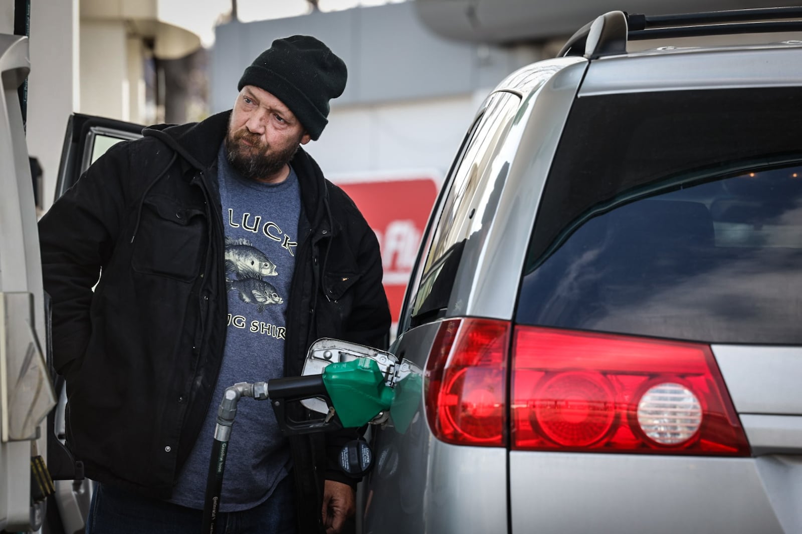 Mark Frawleg, from Dayton, pumps gas at the BP on Edwin C. Moses Boulevard Tuesday, Dec. 3, 2024. AAA projects 4.9 million Ohioans will travel over the 10-day year-end holiday travel period, a 2.9% increase over 2023 that surpassed a pre-pandemic number of 4.8 million and sets a new record. JIM NOELKER/STAFF