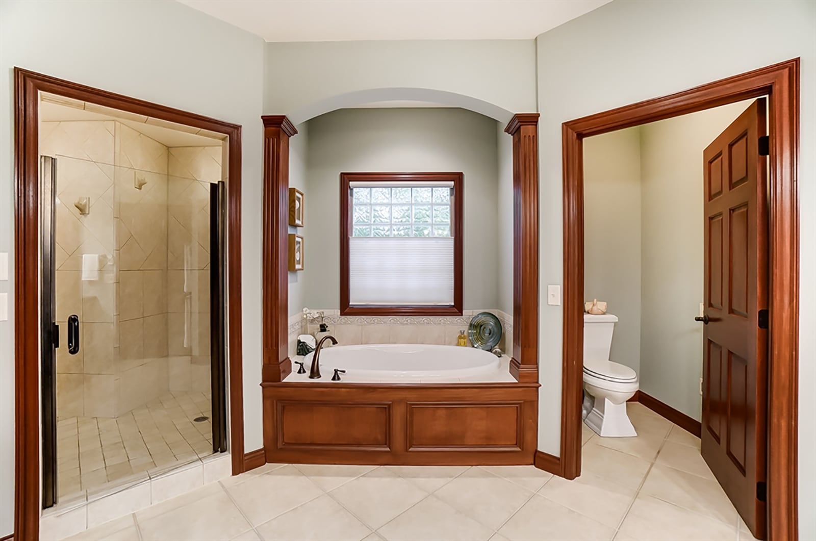 The main bedroom suite’s bath features a double sink vanity with make-up desks, heated ceramic-tile flooring, walk-in ceramic-tile shower with two separate shower bays, a garden tub below a glass-block window and a walk-in closet with built-in organizers. CONTRIBUTED PHOTO