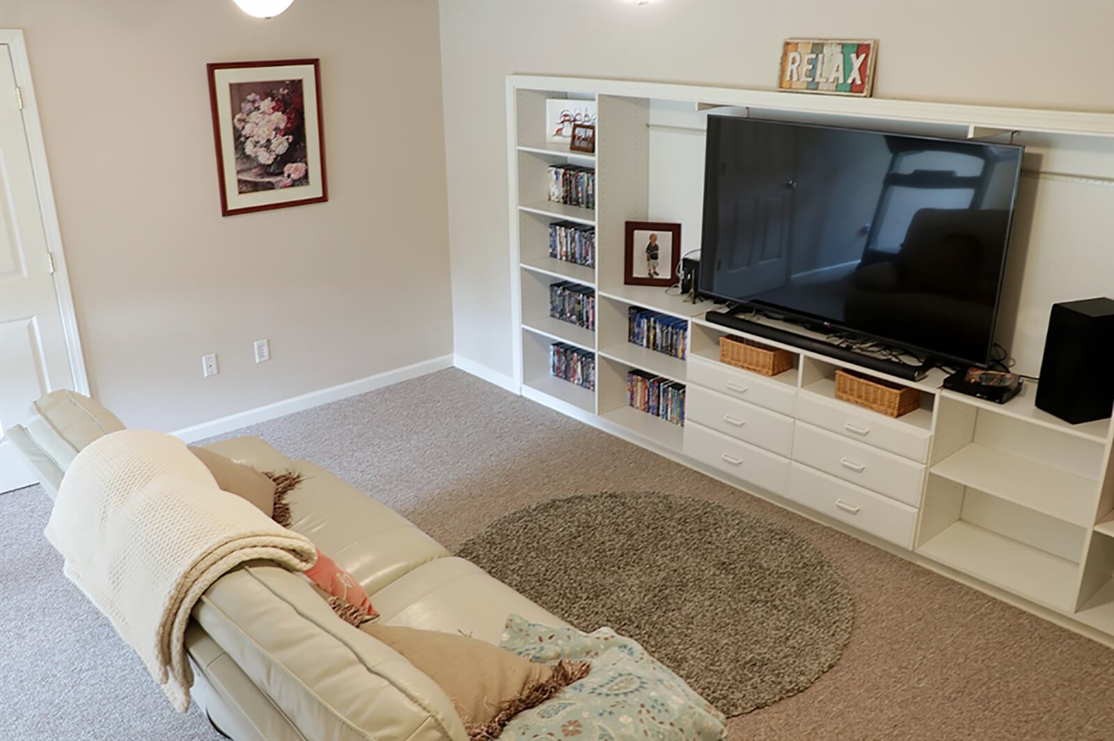 The walk-out lower level has a recreation room with a wall of built-in media nooks and shelves. CONTRIBUTED PHOTO BY KATHY TYLER