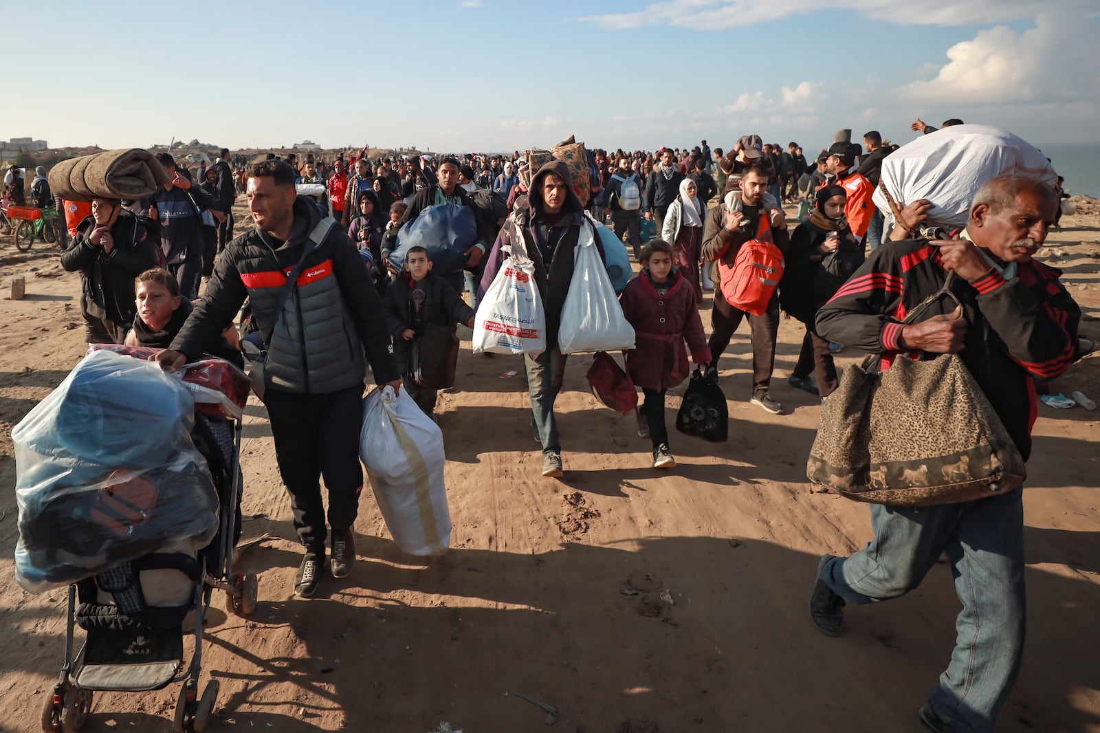 Displaced Palestinians arrive in the northern Gaza Strip, following Israel's decision to allow thousands of them to go back for the first time since the early weeks of the 15-month war with Hamas, Monday, Jan. 27, 2025. (AP Photo/Abed Hajjar)