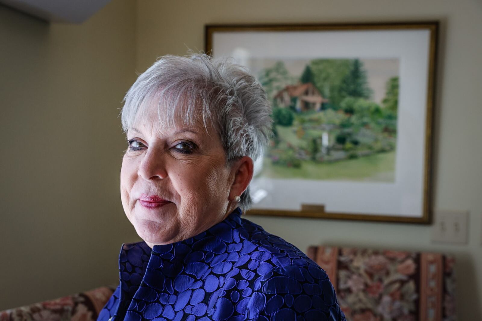 Carol Collins is the Director of Leisure Service and Horticulture for the City of Oakwood. The painting behind Collins is Smith Gardens. JIM NOELKER/STAFF