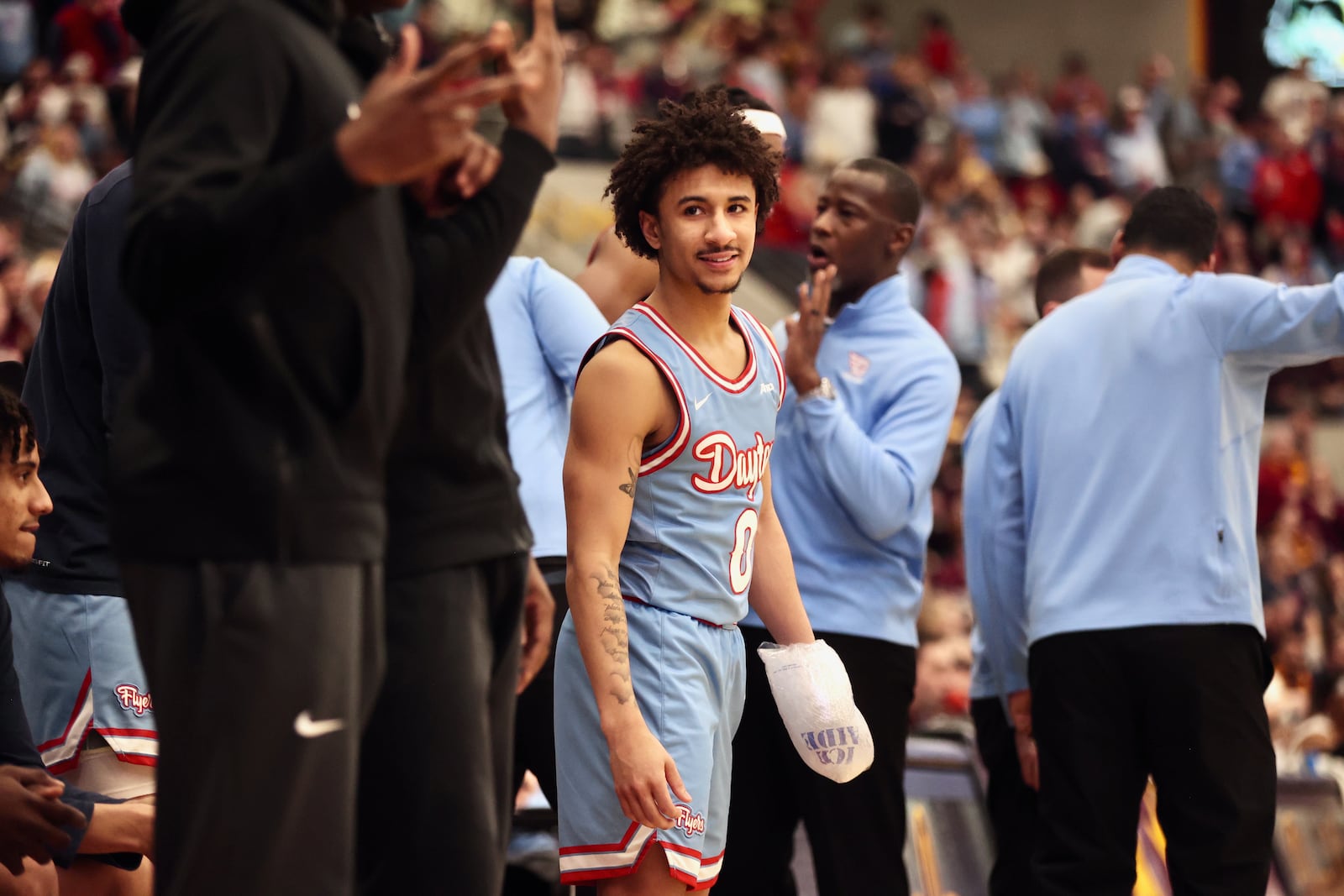 Dayton's Javon Bennett stands on the bench in the second half with ice on his left hand during a game against Loyola Chicago on Friday, March 1, 2024, at Gentile Arena in Chicago. David Jablonski/Staff