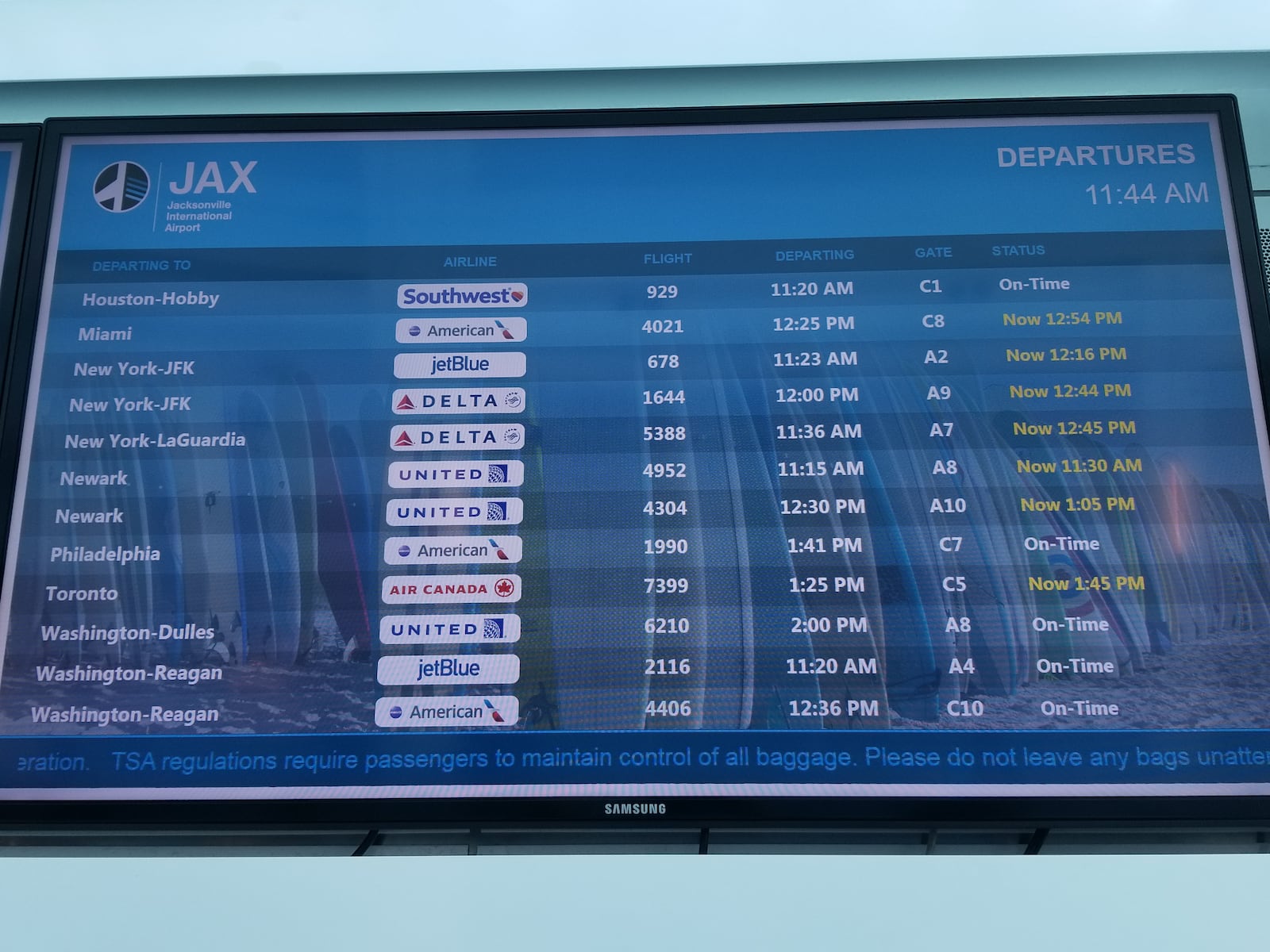 A flight information display shows delayed flights on January 25, 2019 at Jacksonville International Airport. The delays were caused by shortages of air traffic controllers at two major Federal Aviation Administration facilities.