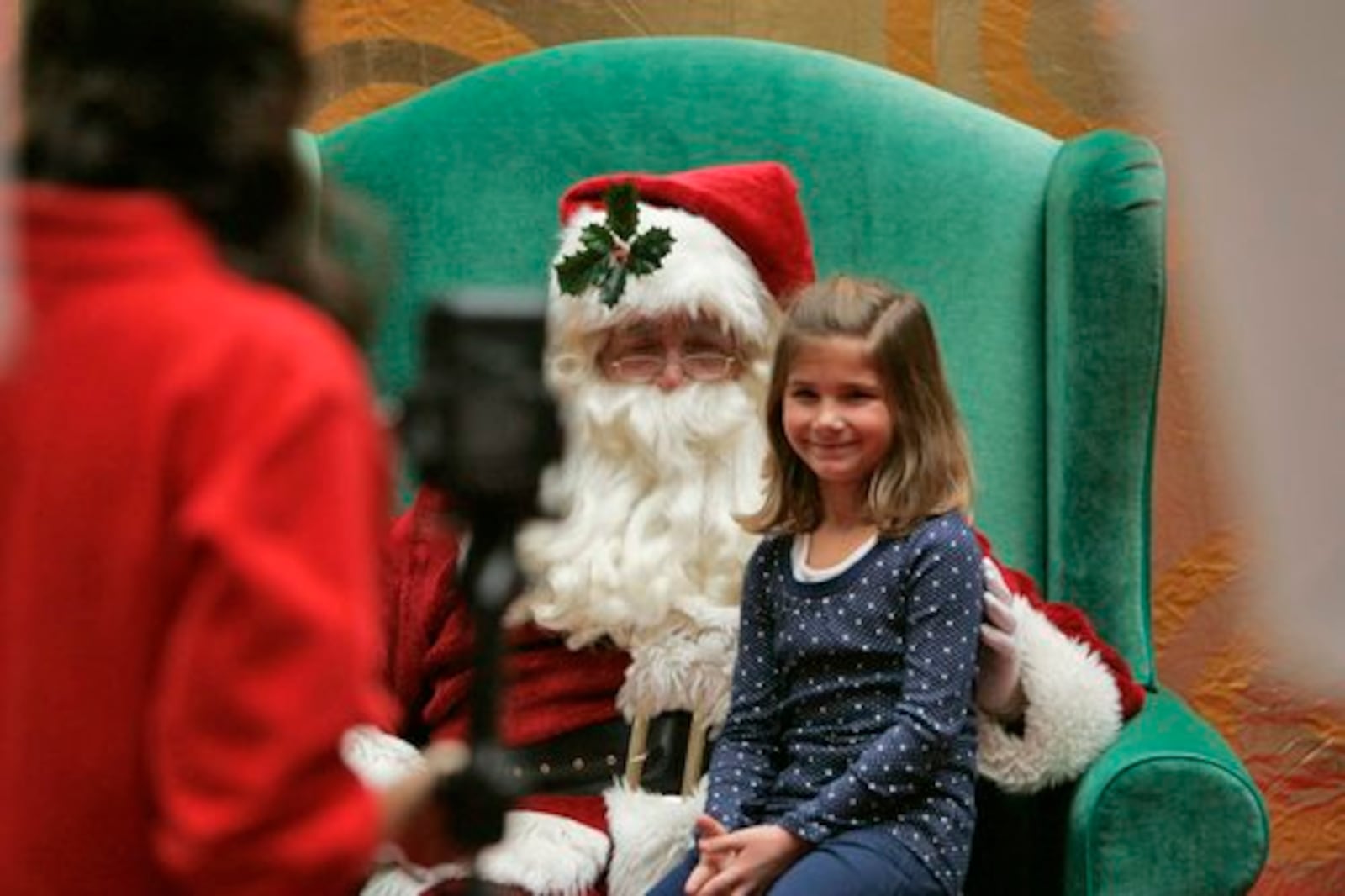 Santa Claus visits with children at the Dayton Mall in this file photo. Children will not be able to sit on Santa's lap this year. JIM NOELKER/STAFF