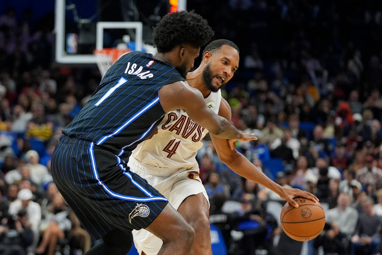 Cleveland Cavaliers forward Evan Mobley (4) collides with Orlando Magic forward Jonathan Isaac (1) as he moves to get around him during the second half of an NBA basketball game, Tuesday, Feb. 25, 2025, in Orlando, Fla. (AP Photo/John Raoux)