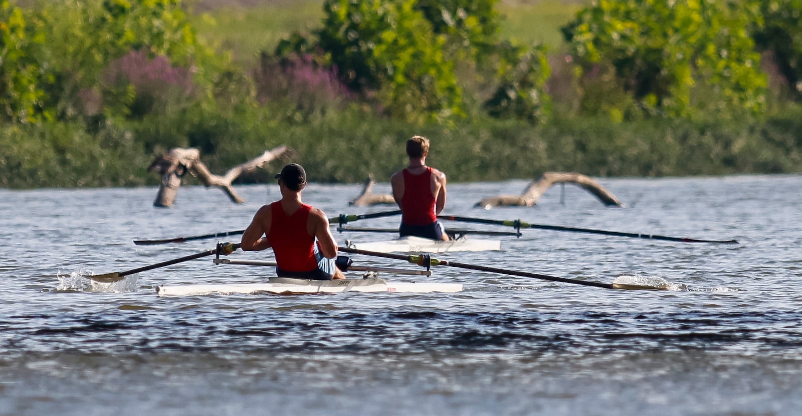 Gary Rought, 17, left, and Malachi Anderson, 17, practice Thursday, Aug. 25, 2022 in Hamilton. Rought and Anderson and others with The Great Miami Rowing Club are heading to Wales where they will be training for and then competing in the 2022 World Coastal Championships and Beach Sprint Finals. NICK GRAHAM/STAFF