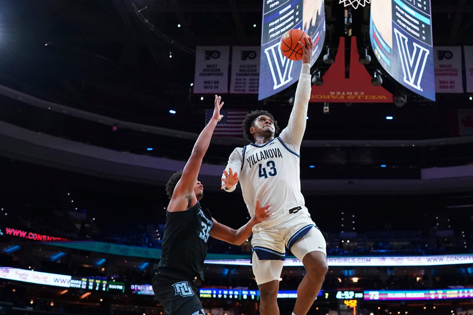 Villanova's Eric Dixon, right, goes up for a shot against Marquette's Caedin Hamilton during the second half of an NCAA college basketball game, Friday, Feb. 21, 2025, in Philadelphia. (AP Photo/Matt Slocum)