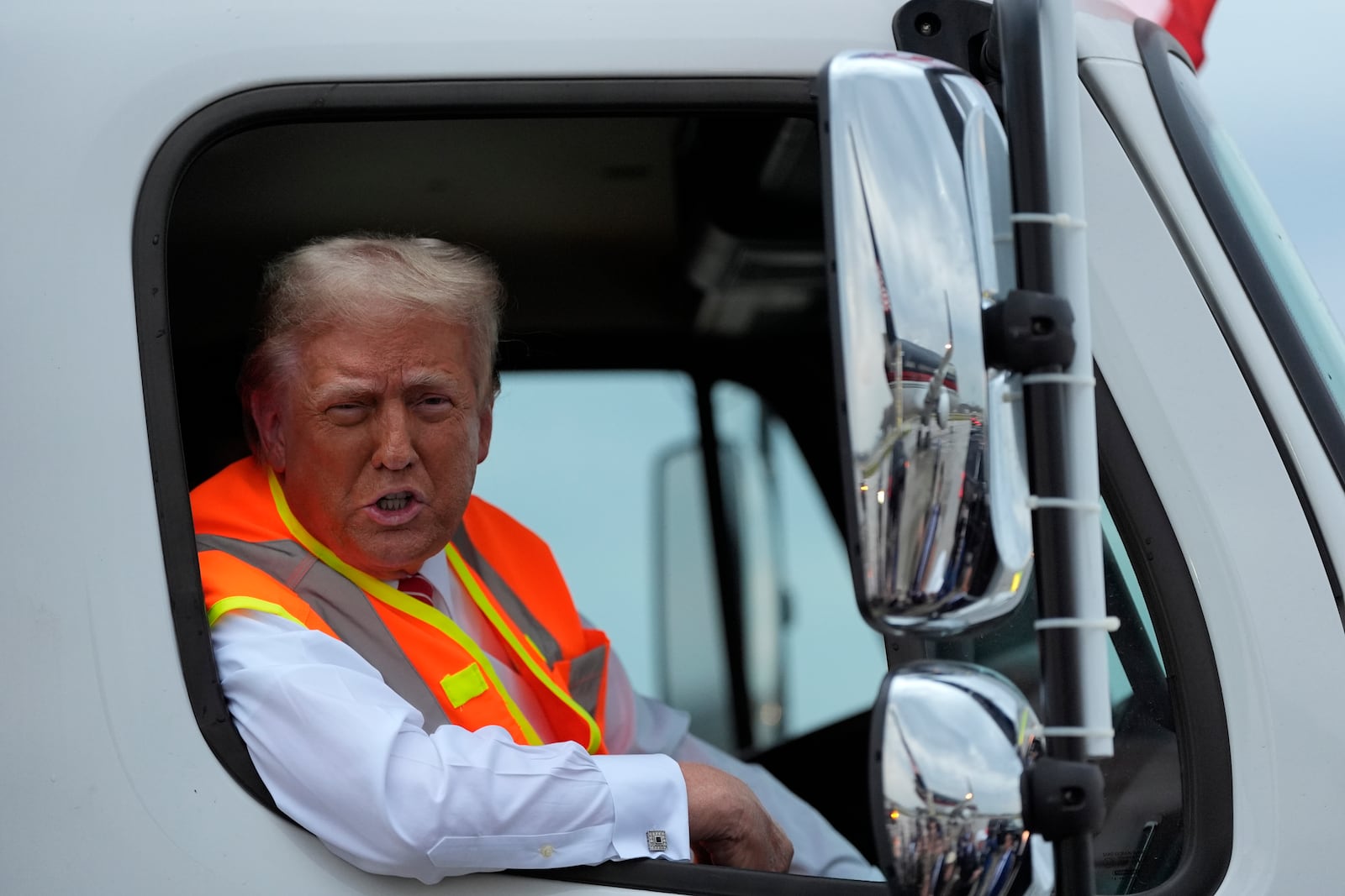 Republican presidential nominee former President Donald Trump talks to reporters as he sits in a garbage truck Wednesday, Oct. 30, 2024, in Green Bay, Wis. (AP Photo/Julia Demaree Nikhinson)