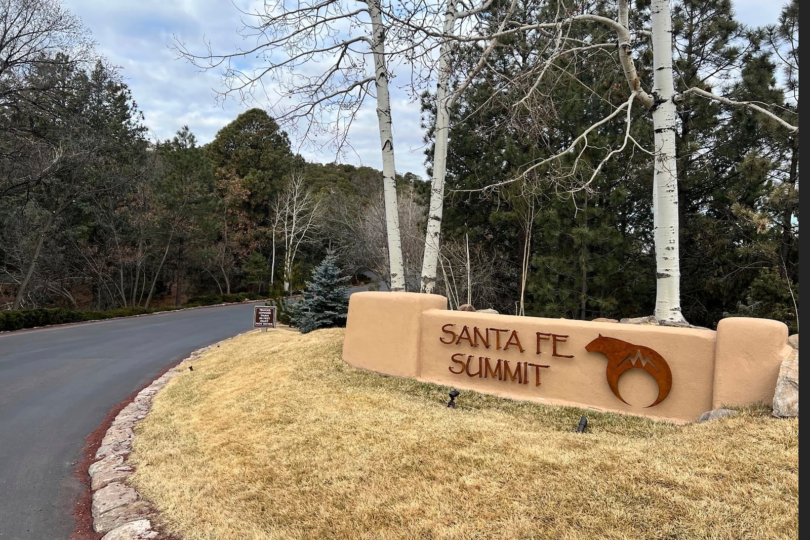 The entrance to the gated community where actor Gene Hackman, his wife Betsy Arakawa and their dog were found dead in their home is shown Thursday, Feb. 27, 2025 in Santa Fe, N.M. (AP Photo/Roberto Rosales)