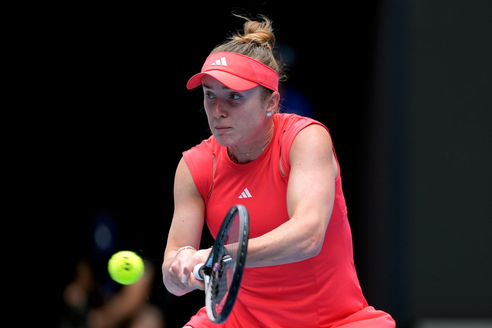 Elina Svitolina of Ukraine plays a backhand return to Madison Keys of the U.S. during their quarterfinal match at the Australian Open tennis championship in Melbourne, Australia, Wednesday, Jan. 22, 2025. (AP Photo/Ng Han Guan)