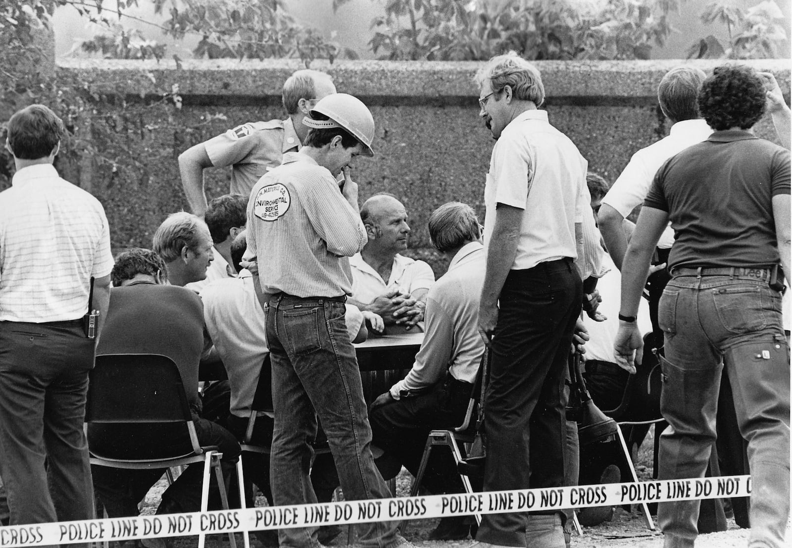 Workers plan strategy early on July 8, 1986 after a train derailed in Miamisburg and its white phosphorous cargo caught fire.  Charles Steinburnner / Staff